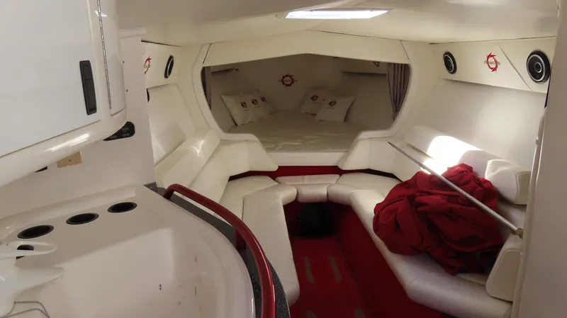  Yacht Photos Pics Interior of 2002 Fountain 47 Lightning boat with white seating and red accents.