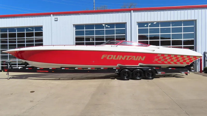  Yacht Photos Pics 2002 Fountain 47 Lightning speedboat with red and white design on a trailer.
