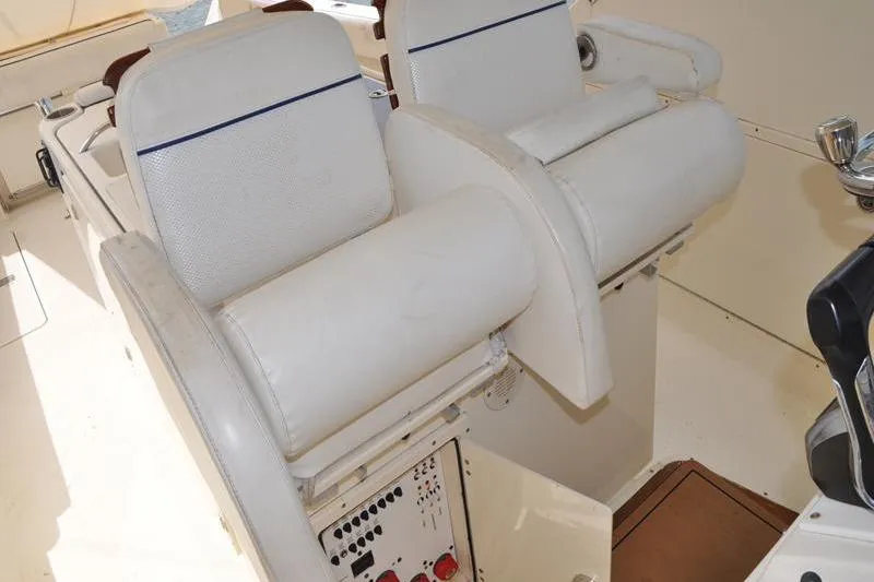  Yacht Photos Pics 2006 Pursuit 345 Drummond Sportfish boat interior with white seating and control panel.