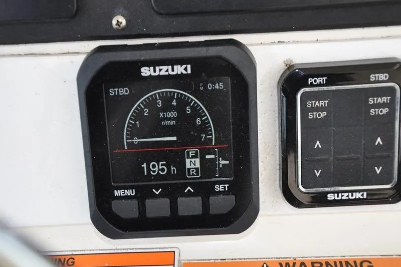  Yacht Photos Pics Suzuki engine control panel on 2006 Pursuit 345 Drummond Sportfish boat, showing 195 hours.