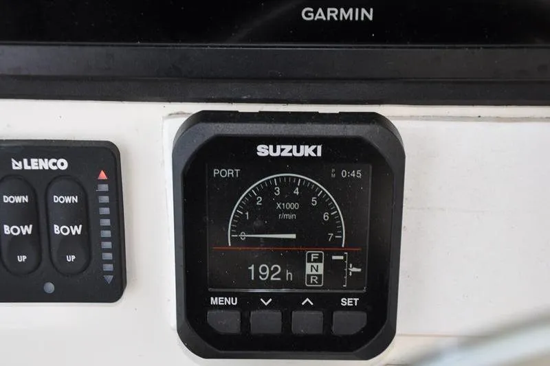  Yacht Photos Pics Control panel of a 2006 Pursuit 345 Drummond Sportfish boat with Suzuki gauge.