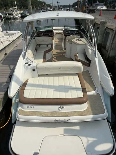  Yacht Photos Pics 2015 Cobalt 302 boat with spacious seating, docked at a marina.