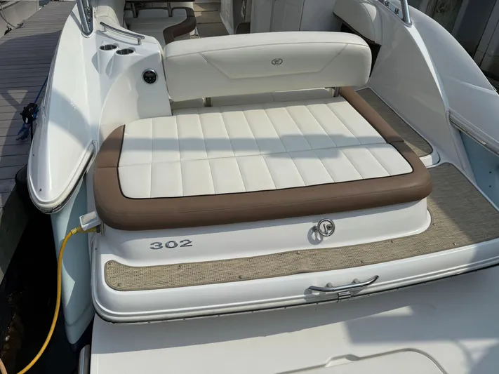  Yacht Photos Pics 2015 Cobalt 302 boat with white and brown seating, docked at marina.