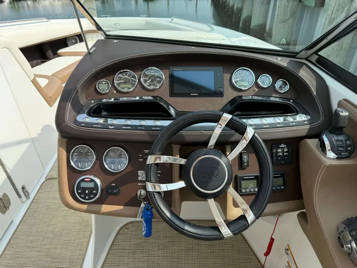  Yacht Photos Pics 2015 Cobalt 302 boat dashboard with steering wheel and control panel.