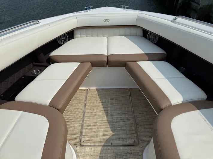  Yacht Photos Pics 2015 Cobalt 302 boat interior with white and brown cushioned seating.