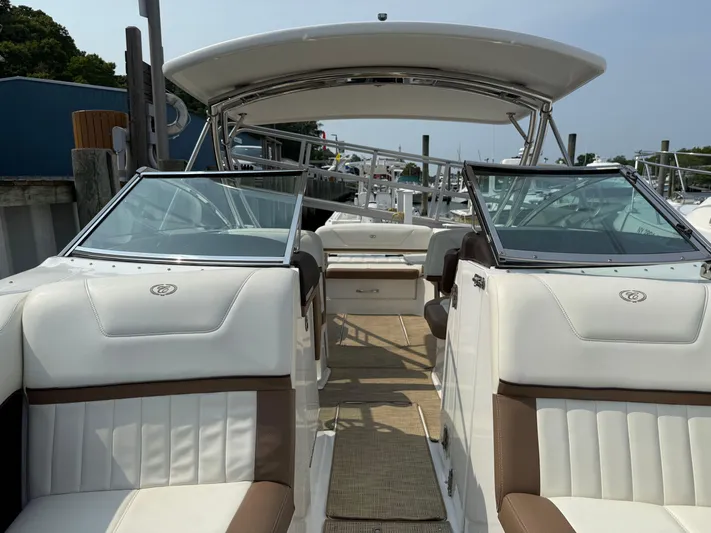  Yacht Photos Pics 2015 Cobalt 302 boat interior with white and brown seating, docked at marina.