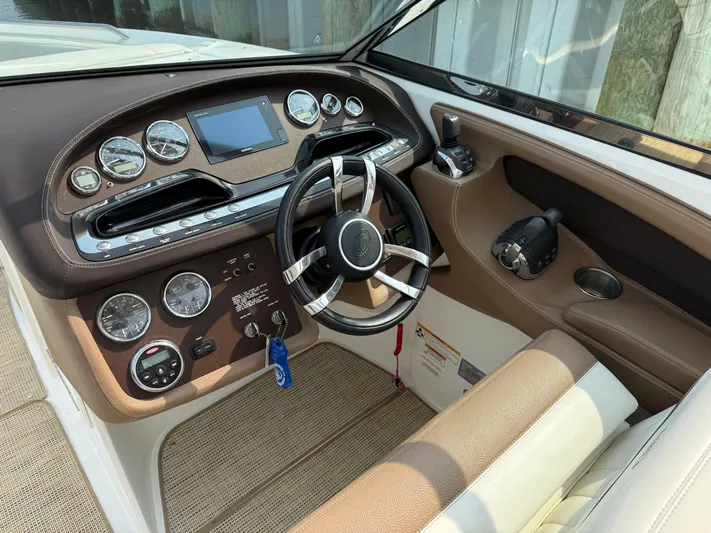  Yacht Photos Pics Interior of a 2015 Cobalt 302 boat showing steering wheel and dashboard controls.