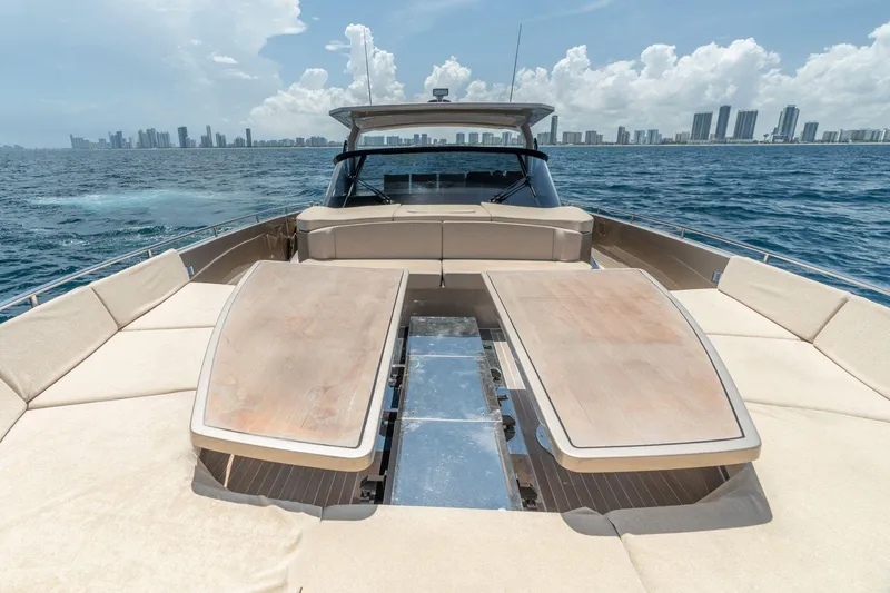 Spin Yacht Photos Pics Luxurious 2019 CNM Continental 54 yacht with spacious deck, cruising near city skyline.