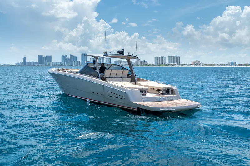 Spin Yacht Photos Pics Luxury CNM Continental 54 yacht cruising near city skyline, 2019 model.