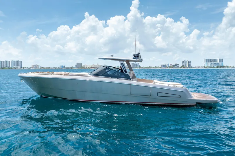 Spin Yacht Photos Pics 2019 CNM Continental 54 yacht on blue ocean with city skyline background.
