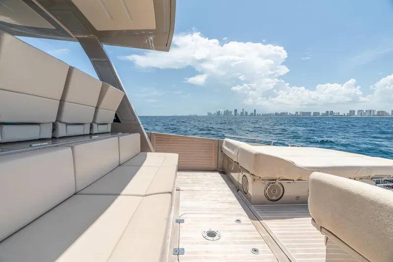 Spin Yacht Photos Pics Luxurious 2019 CNM Continental 54 yacht with spacious deck, ocean view, and city skyline.