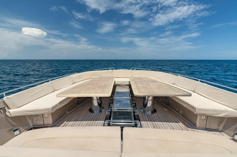 Spin Yacht Photos Pics Luxurious CNM Continental 54 yacht deck with seating and tables, 2019 model, ocean view.