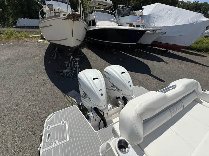  Yacht Photos Pics 2022 Regal 36 XO boat with twin Yamaha V8 engines in a storage yard.