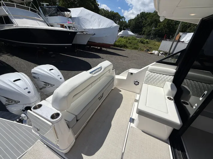  Yacht Photos Pics 2022 Regal 36 XO boat interior with seating and twin Yamaha V8 engines.