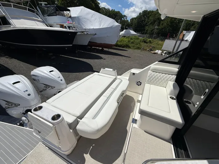  Yacht Photos Pics 2022 Regal 36 XO boat interior with white seating and twin outboard engines.