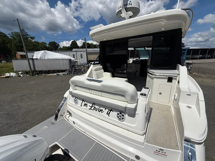  Yacht Photos Pics 2022 Regal 36 XO yacht with open deck and seating, docked outdoors.