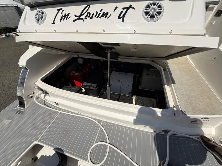 Yacht Photos Pics 2022 Regal 36 XO boat engine compartment with open hatch and "I'm Lovin' it" text.