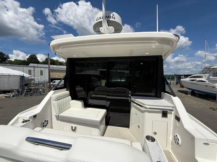  Yacht Photos Pics 2022 Regal 36 XO yacht with spacious seating and modern design under a clear sky.