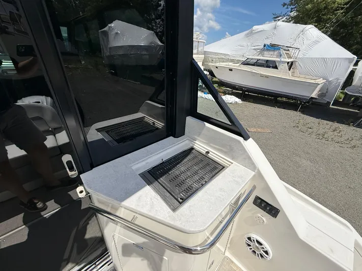  Yacht Photos Pics 2022 Regal 36 XO boat interior with grill and seating area.