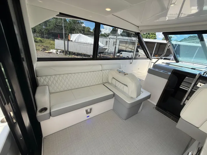  Yacht Photos Pics Luxurious interior of 2022 Regal 36 XO yacht with elegant seating and panoramic windows.