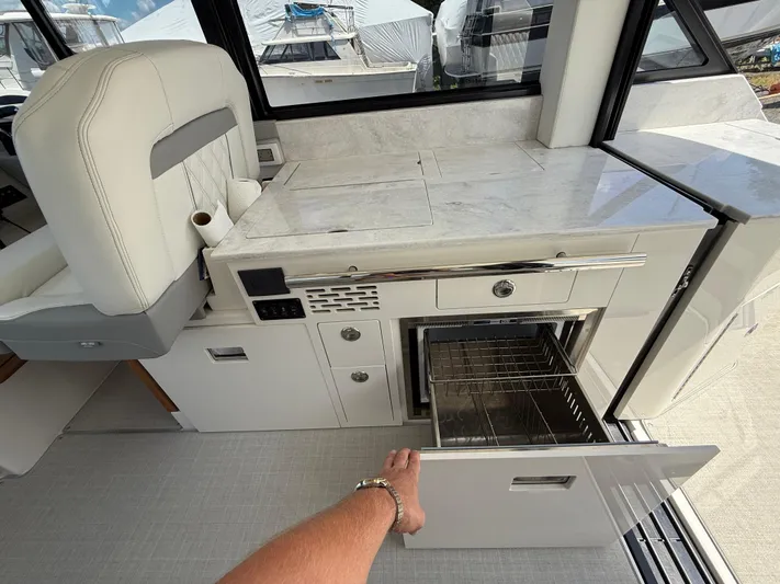  Yacht Photos Pics 2022 Regal 36 XO yacht interior with open drawer and modern kitchen amenities.