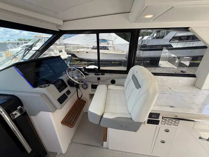 Yacht Photos Pics Interior of 2022 Regal 36 XO yacht cockpit with modern controls and seating.
