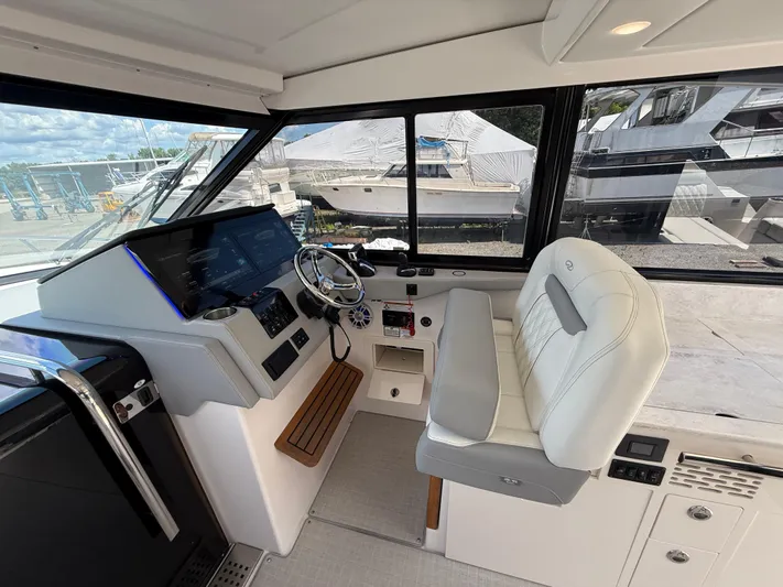  Yacht Photos Pics 2022 Regal 36 XO boat helm with modern controls and comfortable seating.