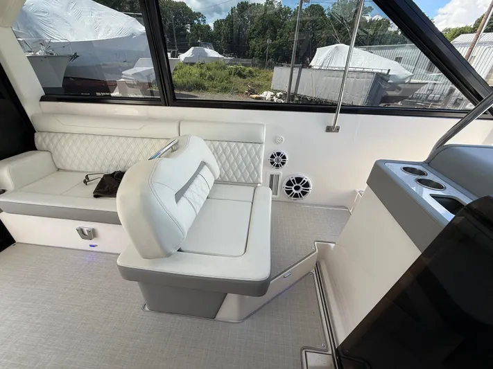  Yacht Photos Pics 2022 Regal 36 XO boat interior with white seating and cup holders.
