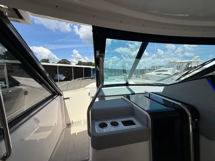  Yacht Photos Pics Interior view of 2022 Regal 36 XO yacht cockpit with clear windows and modern design.