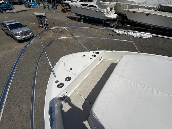  Yacht Photos Pics 2022 Regal 36 XO boat deck with seating and cup holders in a marina.