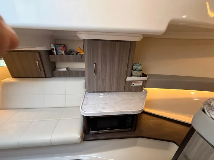  Yacht Photos Pics Interior of 2022 Regal 36 XO yacht with modern cabinetry and seating.