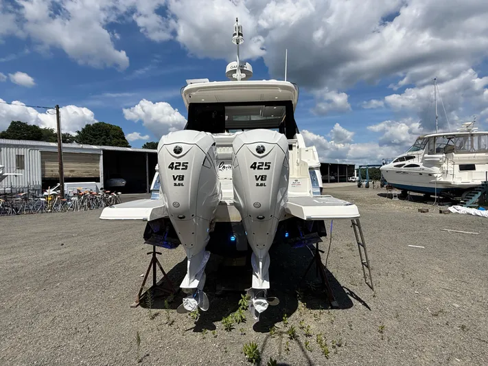  Yacht Photos Pics 2022 Regal 36 XO boat with twin 425 V8 engines, parked outdoors under a cloudy sky.