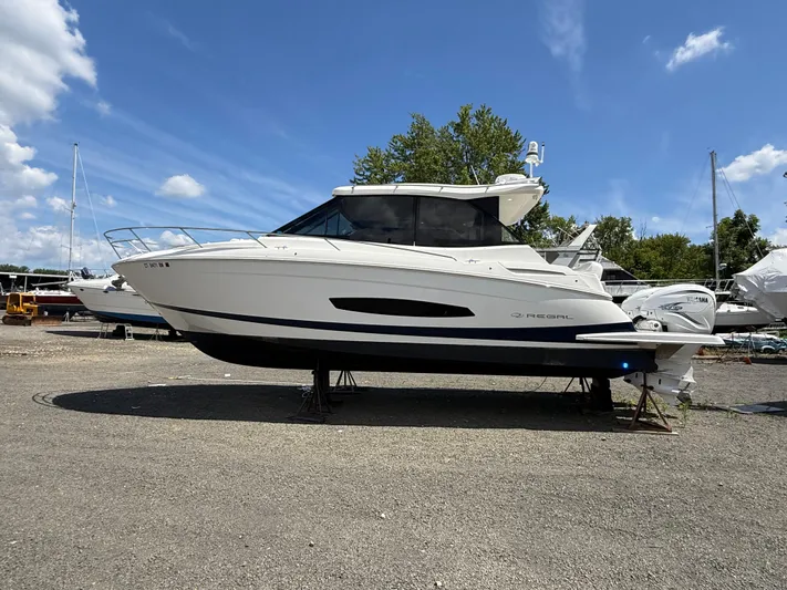  Yacht Photos Pics 2022 Regal 36 XO boat on display under a clear blue sky.
