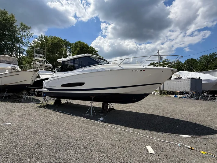  Yacht Photos Pics 2022 Regal 36 XO boat on display under a partly cloudy sky.