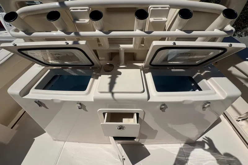 Your New Boat! Yacht Photos Pics 2024 Grady-White Canyon 336 fishing station with rod holders and storage compartments.