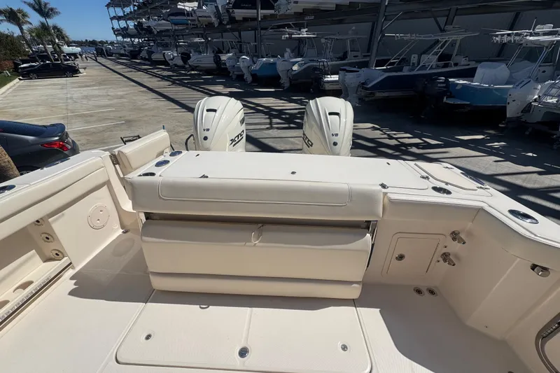 Your New Boat! Yacht Photos Pics 2024 Grady-White Canyon 336 boat interior with dual engines in a marina setting.