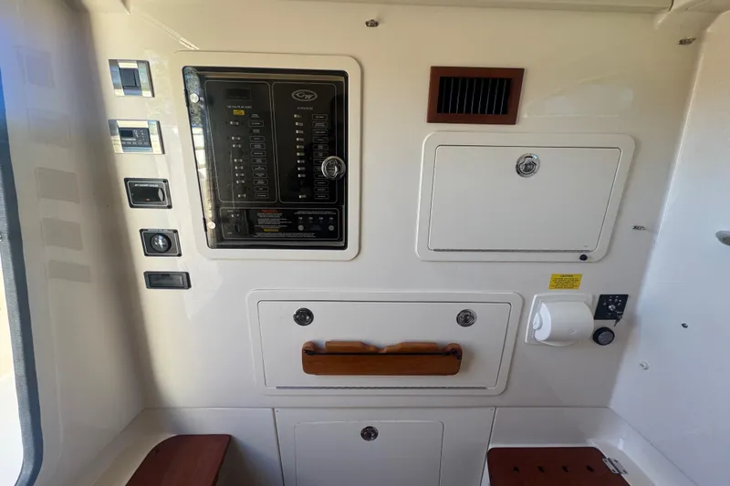Your New Boat! Yacht Photos Pics 2024 Grady-White Canyon 336 control panel with switches and storage compartments.