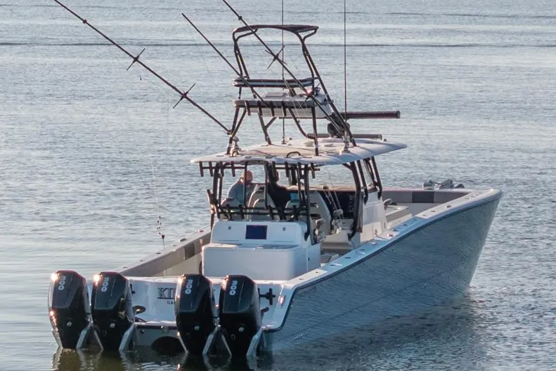  Yacht Photos Pics 2022 Freeman 42 LR boat with multiple outboard motors on calm water.