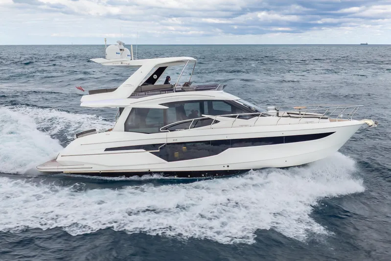 Infinity Yacht Photos Pics 2020 Galeon 500 Fly yacht cruising on open sea under cloudy skies.