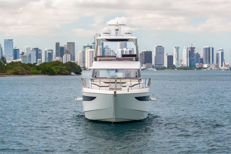 Infinity Yacht Photos Pics 2020 Galeon 500 Fly yacht cruising near city skyline on a sunny day.