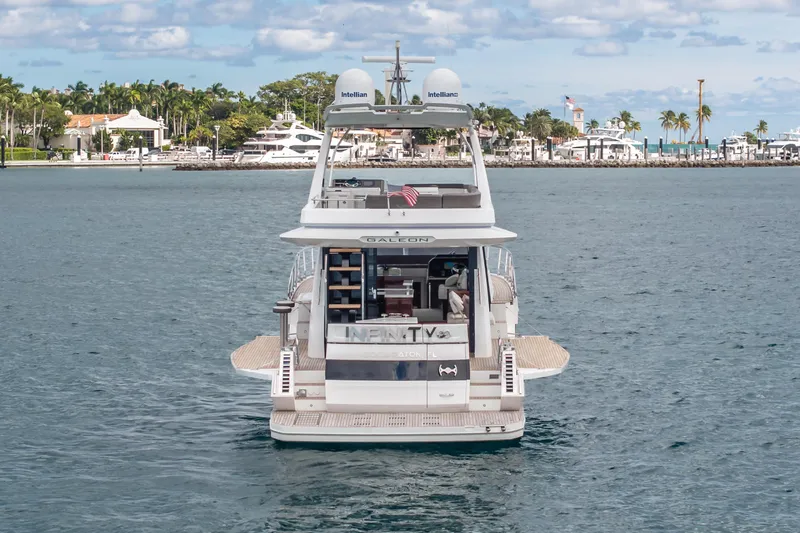 Infinity Yacht Photos Pics 2020 Galeon 500 Fly yacht on water, with scenic coastal backdrop.