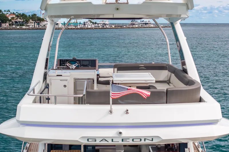 Infinity Yacht Photos Pics 2020 Galeon 500 Fly yacht with American flag, cruising on serene waters.