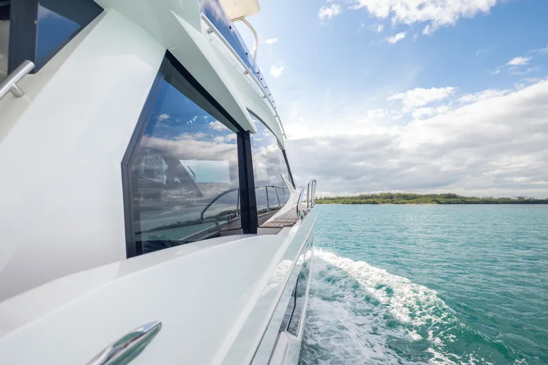 Infinity Yacht Photos Pics 2020 Galeon 500 Fly yacht cruising on clear blue waters under a partly cloudy sky.