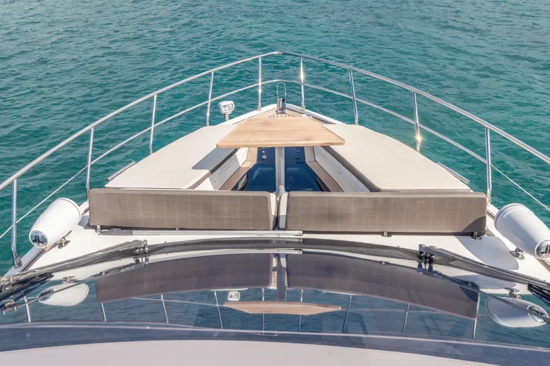 Infinity Yacht Photos Pics Galeon 500 Fly 2020 yacht deck with seating and table, overlooking blue ocean waters.