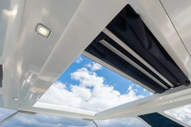 Infinity Yacht Photos Pics Open sunroof on 2020 Galeon 500 Fly yacht, showcasing blue sky and clouds.