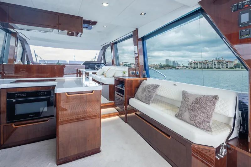 Infinity Yacht Photos Pics Luxurious interior of 2020 Galeon 500 Fly yacht with modern kitchen and seating area.