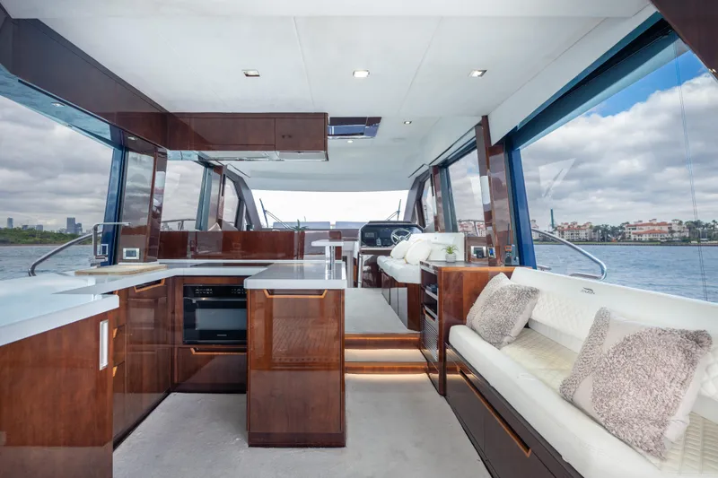 Infinity Yacht Photos Pics Luxurious interior of 2020 Galeon 500 Fly yacht with modern kitchen and seating area.