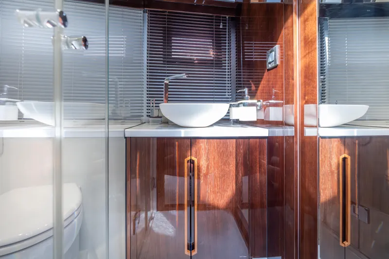 Infinity Yacht Photos Pics Luxurious bathroom interior on 2020 Galeon 500 Fly yacht, featuring sleek wood cabinetry and modern fixtures.