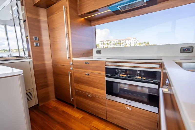 Iseablu Yacht Photos Pics Luxurious kitchen interior on 2023 Princess Y72 yacht with modern appliances and wood finish.