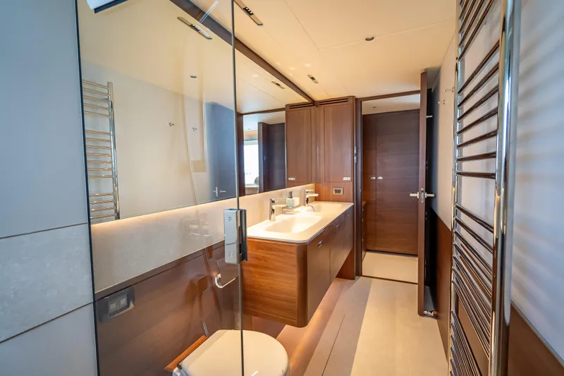 Iseablu Yacht Photos Pics Luxurious bathroom interior of 2023 Princess Y72 yacht, featuring modern fixtures and elegant wood finishes.
